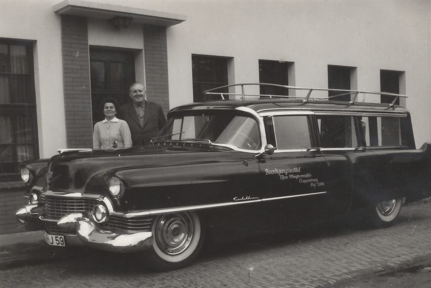 Theo Wingbermühle der Zweite und seine Frau Caroline, genannt Lienchen, vor dem ersten Leichenwagen des Hauses, einem schwarzen Cadillac mit der Aufschrift Beerdigungsinstitut Theo Wingbermühle Cloppenburg